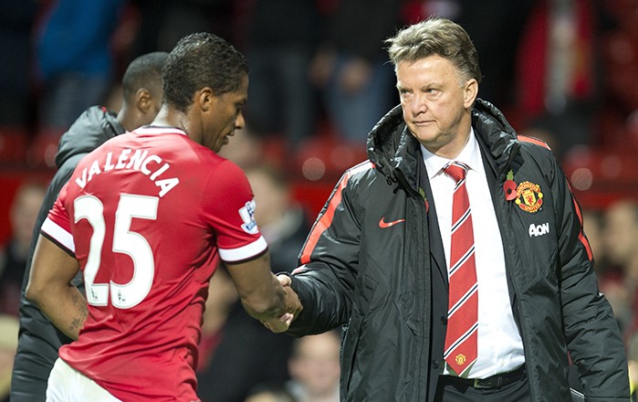 Manchester United's Dutch manager Louis van Gaal (R) shakes hands with Manchester United's Ecuadorian midfielder Antonio Valencia (L) as they leave the pitch after the English Premier League football match between Manchester United and Crystal Palace at Old Trafford in Manchester, north west England, on November 8, 2014.  AFP PHOTO / OLI SCARFF RESTRICTED TO EDITORIAL USE. No use with unauthorized audio, video, data, fixture lists, club/league logos or live services. Online in-match use limited to 45 images, no video emulation. No use in betting, games or single club/league/player publications.        (Photo credit should read OLI SCARFF/AFP/Getty Images)